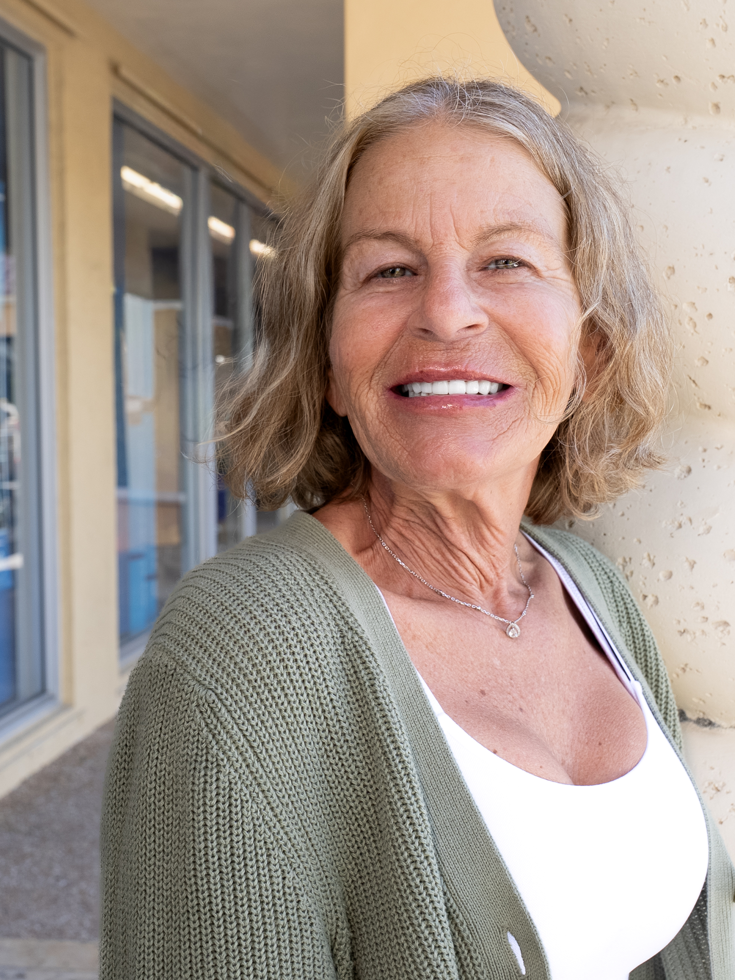 care one dental full arch patient smiling outside